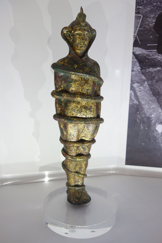 A gold plated bronze figure in the coils of a snake representing an unknown god. Found in 1908 in a shrine to Syrian dieties on Via Dandolo.