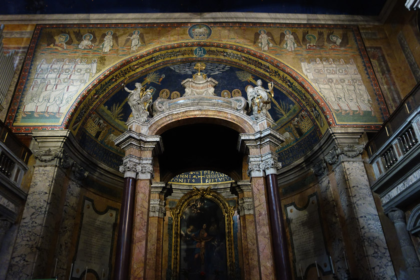 The arch of the apse has a quartet of angels on either side, above a dozen old men holding out gold crowns to Christ.