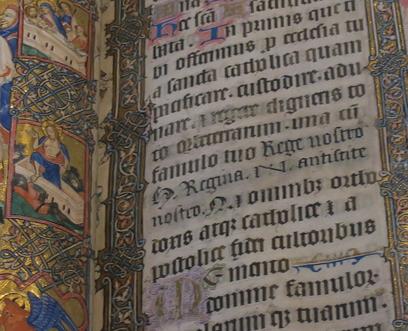 The Gothic text in the left column shows some damage and erasures. The 