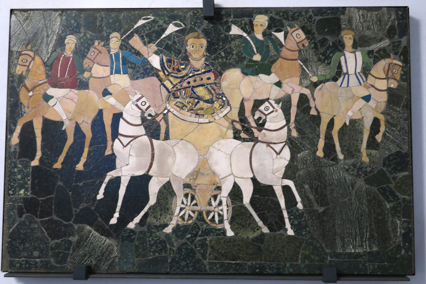 Chariot and four horemen. Opus sectile. First half of 4c AD. Mosaic uses pieces of uniform size in a regular matrix, whereas opus sectile pieces are much larger and are not set in a regular matrix.