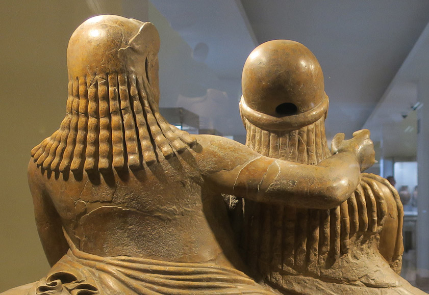 Interesting hairdos. Her braids emerge from under her cap, but his descend from a smooth cap that was not visible from the front.