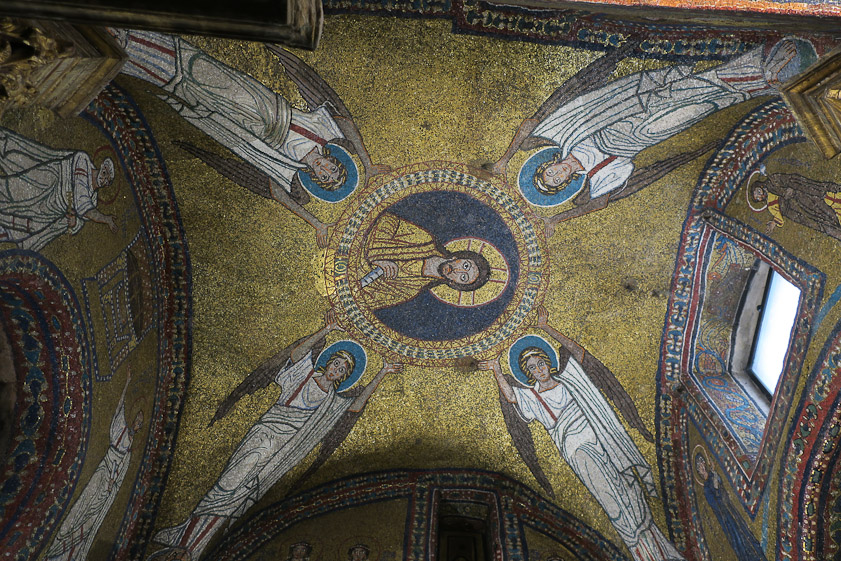 Passing through the entrance you enter a  vaulted space. Christ is surrounded by four angels.