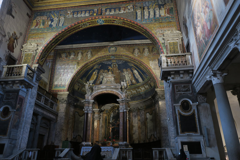 The east end (presbytery) of Santa Praxedes was reworked 1728-34 to respond to the Roman council of 1725 to emphasize the altar in a church. The altar is under the ciborium, which is in front of the apse and under the apse arch. Closer to us is the arch of the triumph.