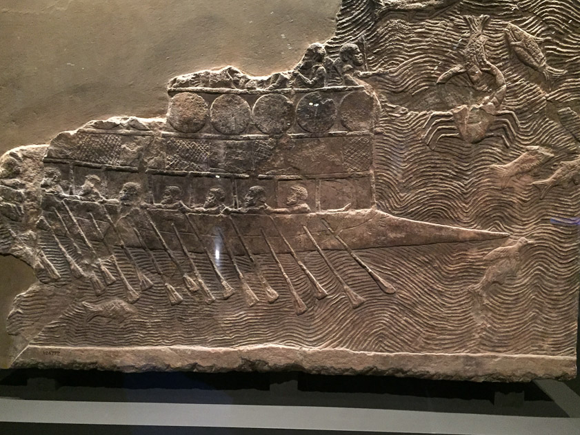 Carved ivory furniture fitting showing an Assyrian war galley.