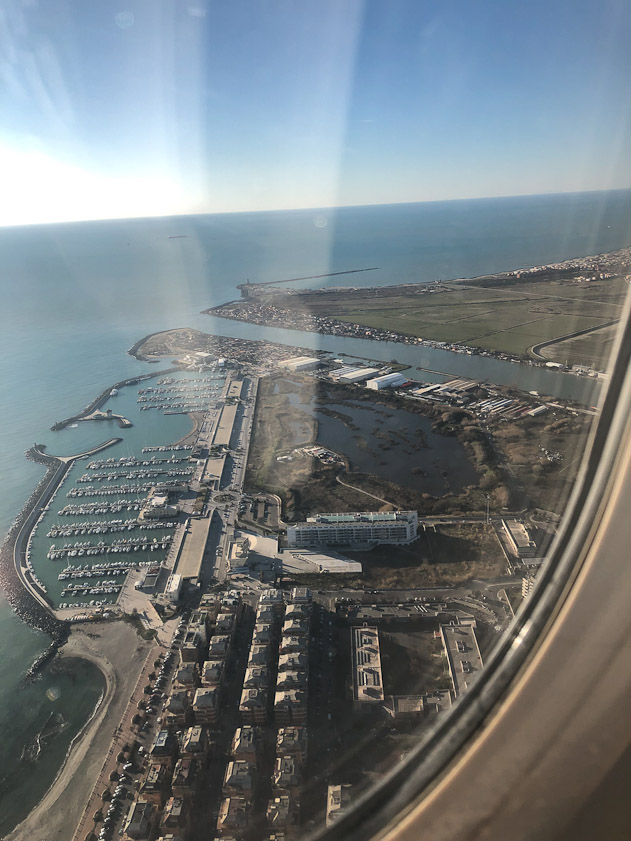 We approached FIumicino Airport from the south. That channel is the Tiber River, entering the Tyrrhenian Sea.