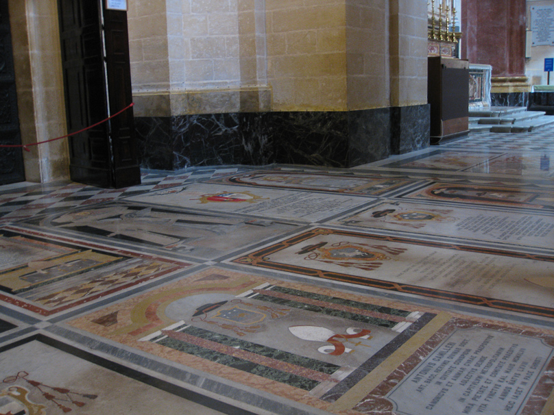 The floor of the Mdina Cathedral is covered with stone intarsia memorials.