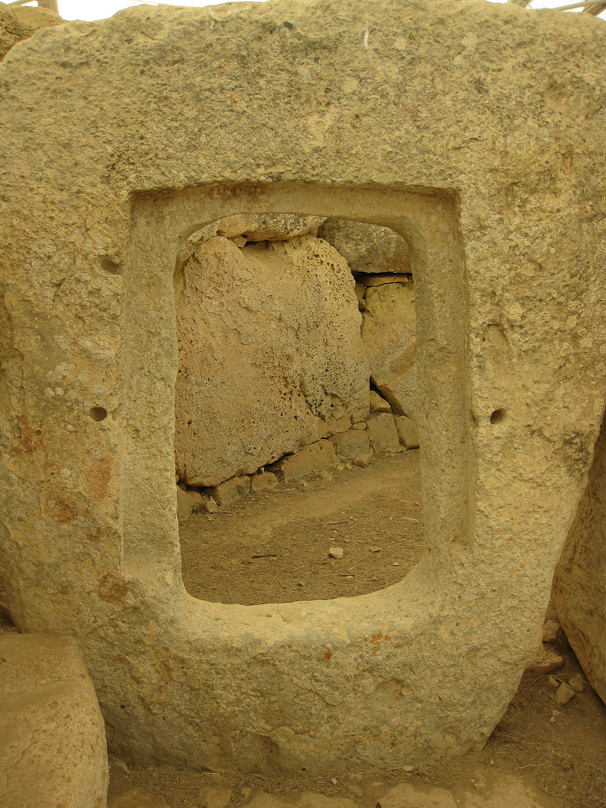 The doorway into an apse at Hagar Qim. There was an interesting display at the Hagar Qim museum where one could handle chert and limestone and appreciate how much harder chert was, making it feasible to quarry and carve limestone with chert-edged tools.