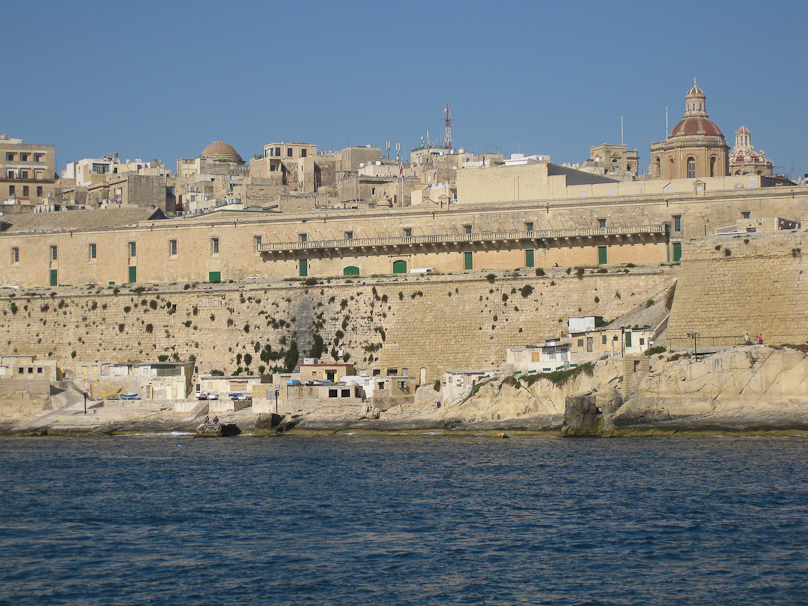 The building with the green doors is the Hospital of the Knights of St. John of Malta. It's now a conference center and a museum.