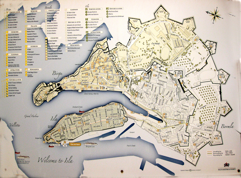 This map shows Birgu (top) and Senglea (a.k.a. Isla) on the bottom. These two peninsulas were held by the Knights of St. John and by Maltese citizens during the Great Siege of 1565. There appears to be three sets of fortifications: the outermost are the Cottonera Lines, built 1723-1761. Within these are the Santa Margerita Lines, built ~1638. There is a third set of lines, one around the end of Senglea and the other across the neck of Birgu. The last stronghold of Birgu, at its tip, is Fort San Angelo and its counterpart on Senglea is Fort St. Michael.