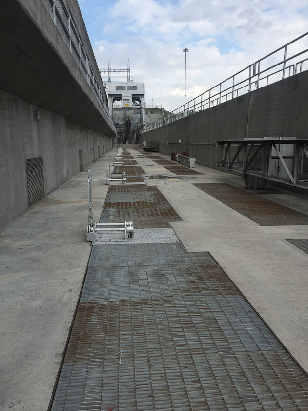 There is a gate under each of the grates. The crane is in the distance.