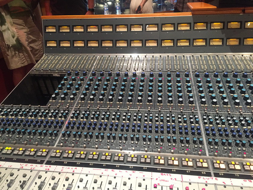 The mixing console consists of dozens of channel strips, each attached to one or a stereo pair of microphones or to a single instrument feed (electric organ, electric guitar, etc.) A channel strip controls the phantom power to the microphones, the pre-amps and power amps, equalizers, volume, combination with effects such as reverberation, level meters and switches to route the signals.