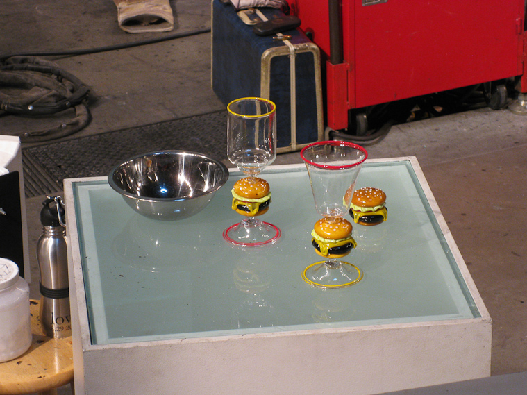 The glasses they are replicating incorporate a cheeseburger made of glass.