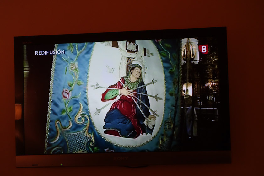 We got tired of standing in the rain and came back to the hotel to watch processions on the TV. This banner carried in a procession shows Mater Dolorosa or Our Lay of Sorrows.