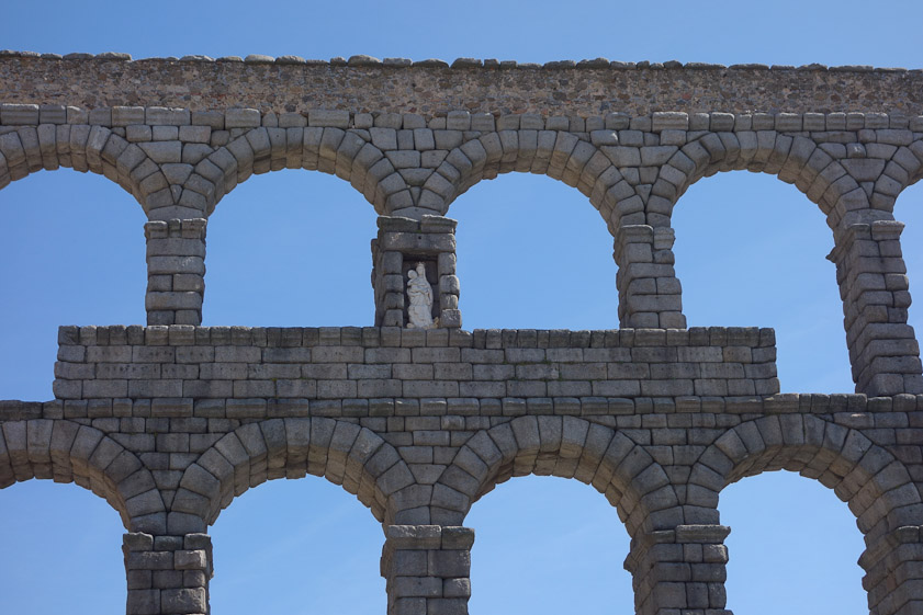 I think this feature was built to hold an inscription of bronze letters, which have disappeared. Analysis of the pin holes in the stone by which the letters were attached has allowed it to be read, however. It was built in the reign of Emperor Trajan in the early 2c AD.