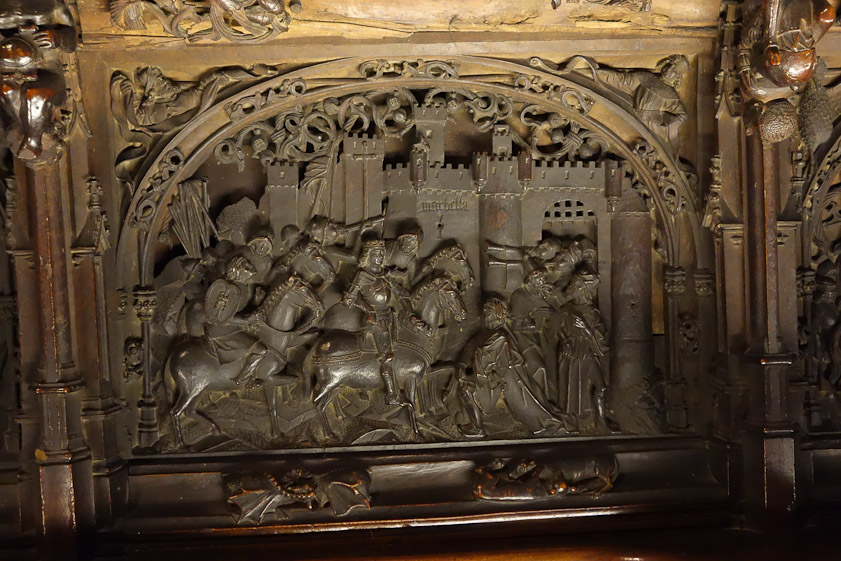 The stallls nside the choir are decorated with scenes of the conquest of Granada in 1492.