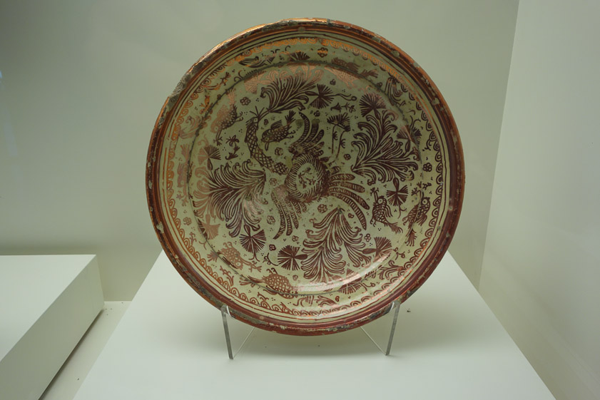 Above the cloister is a display of ceramics. This lustreware plate was made in Manises, near Valencia, in the 18c.