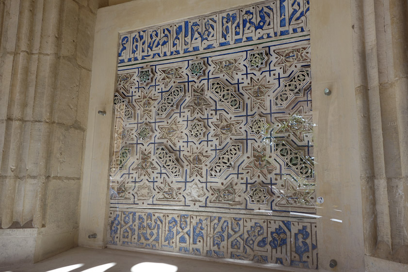 Stucco work, protected by transparent plastic, presumably dating to before the reconquest of Toledo in 1085.