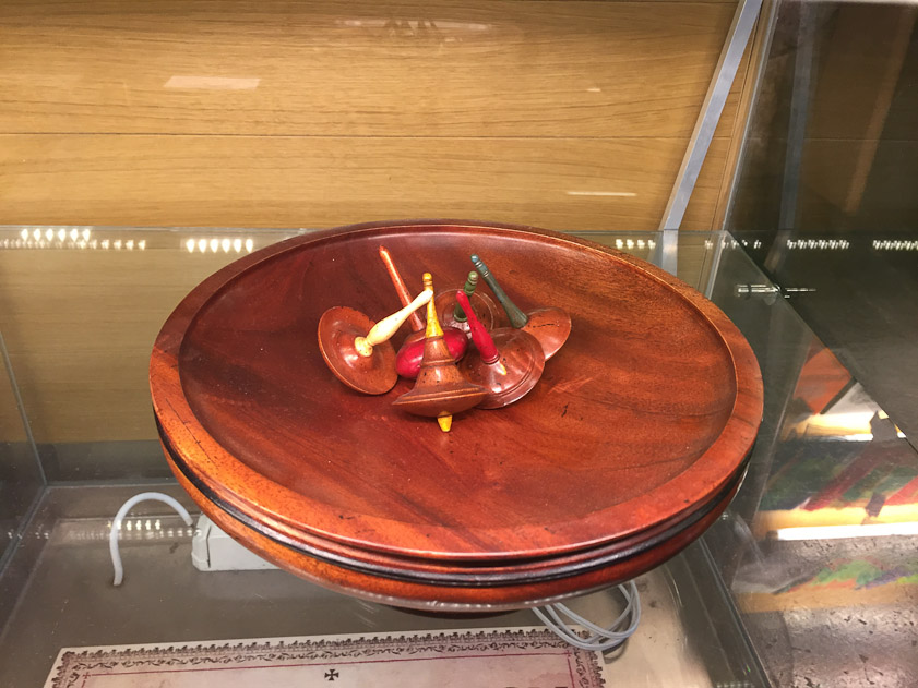 A game of tops for sale in the Salamanca University shop adjacent to Salamanca Cathedral. Evidently the contestants' tops fight it out to determine the last top spinning.
