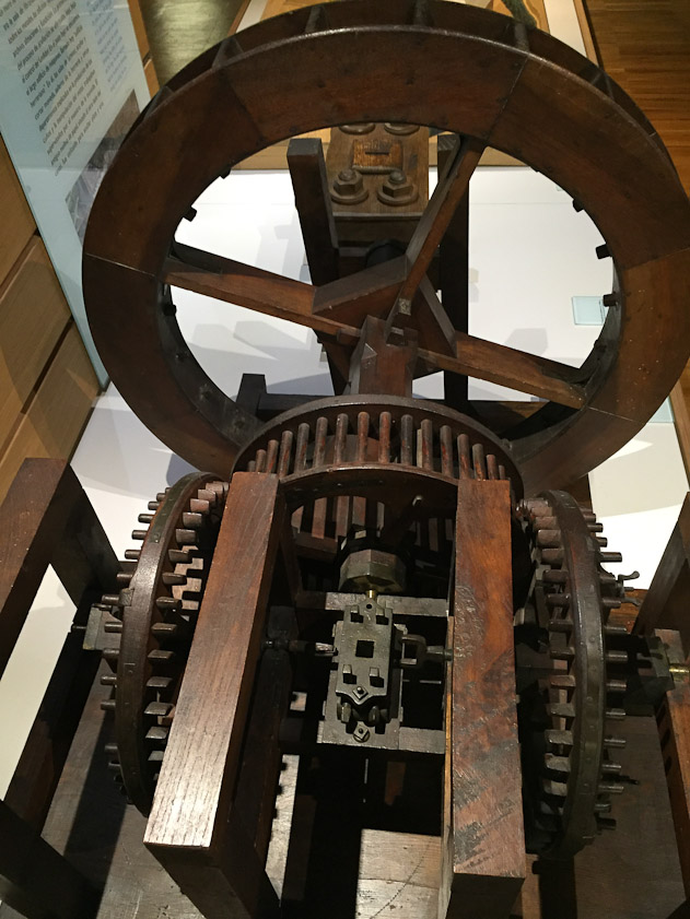 The vertical water wheel at the back drove the cage gear, which drove two crown gears in opposite directions. They drove the cointing and laminating mill between them.