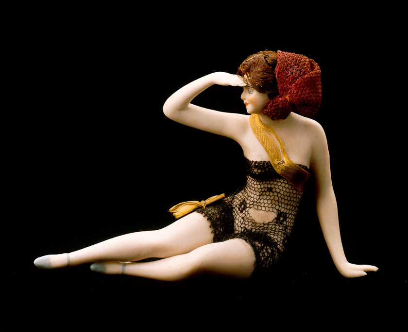 Ceramic, with cloth costume and artificial hair.