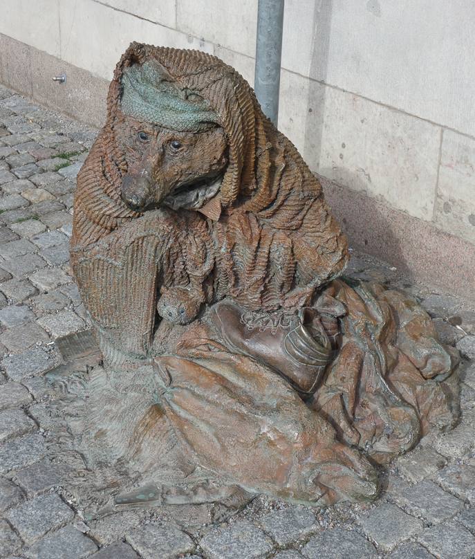 This bronze figure below the memorial is called 