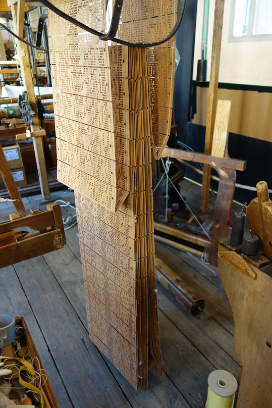 Each card corresponds to one weft thread, so the total card deck represents one repeat of the fabric pattern.