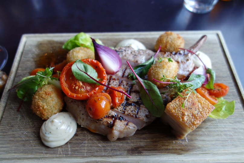 The main course, a grilled pork chop.