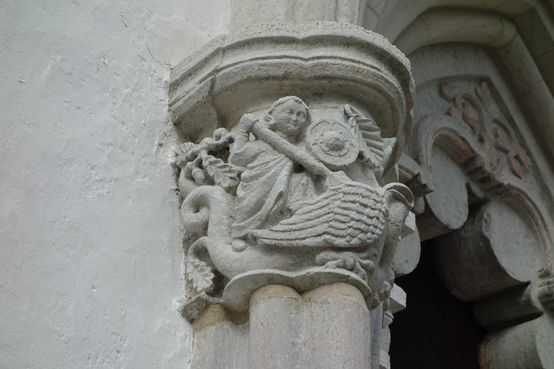 This prototype putti is defending Mary from a dragon.