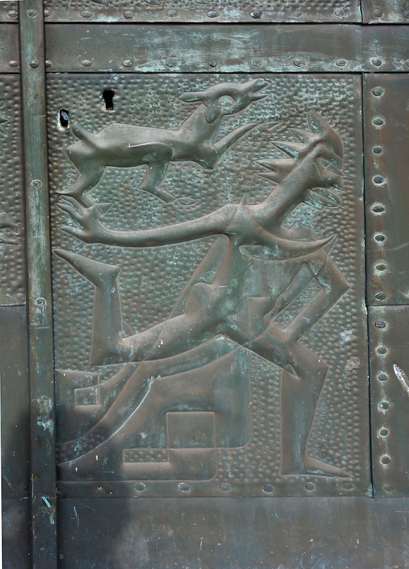 I can see a running figure in the bottom right panel, with human arms and legs but a bird's head with a a ruff of feathers on the back. This is running in front of another, seated figures that I cannot make out. Above this figure is a dog.