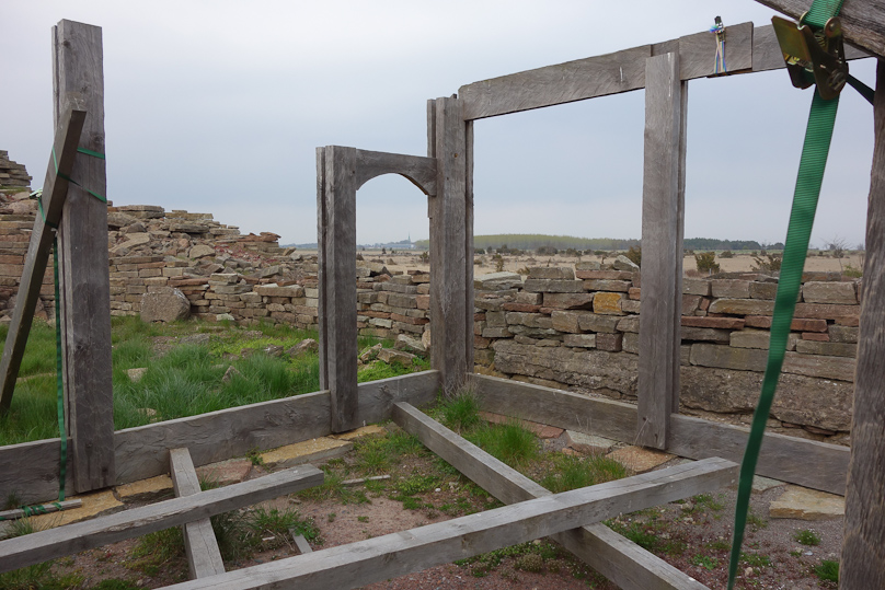 The corner posts and door frame are slotted, to hold the horizontal wall timbers