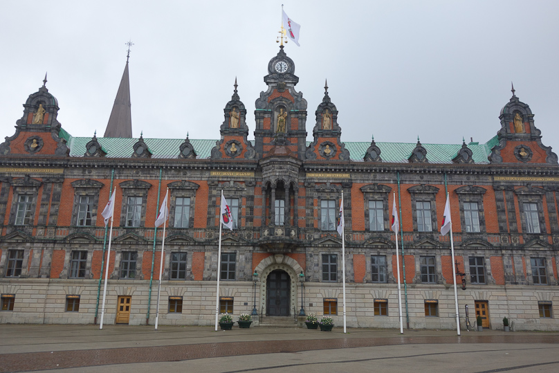 The Malmö city hall, with the spire of S:t Petri kyrka behind it.