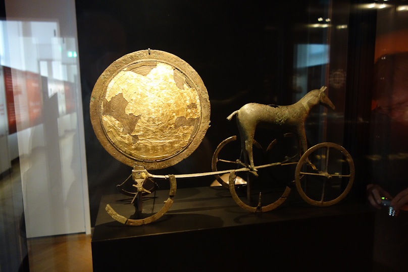 Bronze Age religion centered on the journey of the sun by day through the sky and by night through the darkenss of the underworld. The day voyage was made by a chariot drawn by a divine horse, and the night return was by ship. Other means of transport were fish, snakes and water birds. This chariot of the sun was made c. 1400 BC.