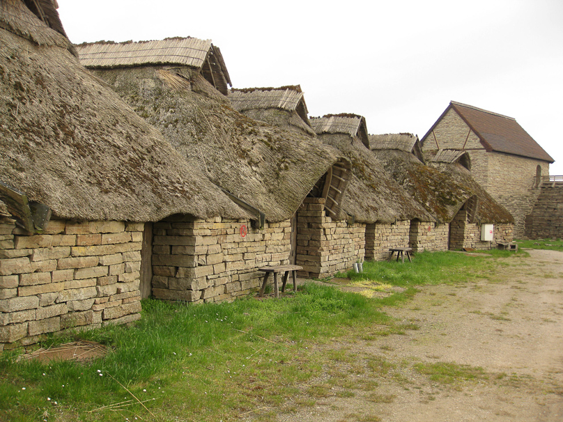 A row of stone buildings, with openings at the top to let out smoke.
