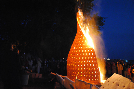 It was fired in place. In this image from the website http://m.youtube.com/watch?v=LM-_BfifybI. It was made by Åke and Eva Nobling of Lokatta Keramik (http://www.noblingceramics.com) The fuel was wood, and the kiln was the thin white material at the bottom, which has fallen away from the 